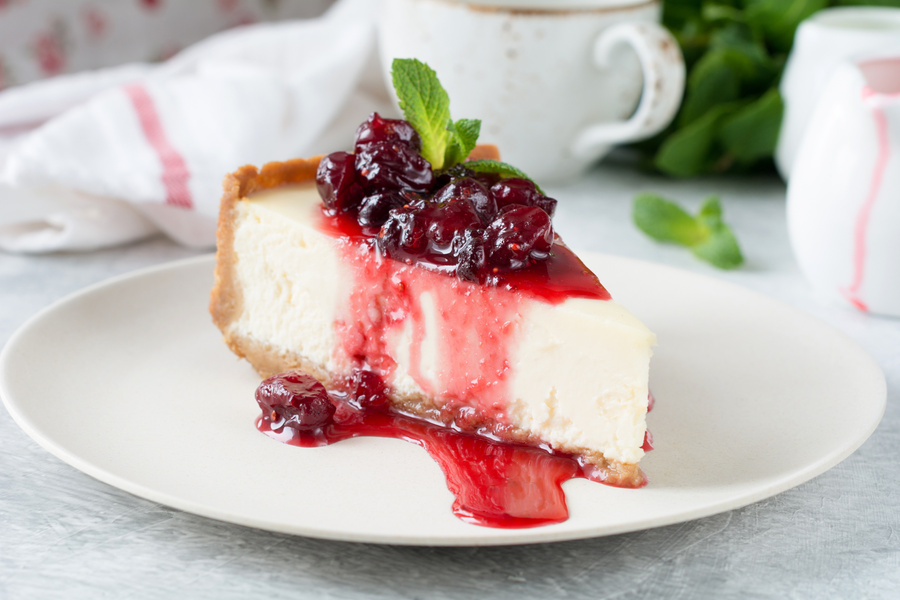 Slice of cheesecake with berry sauce